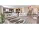 Open-concept living room and kitchen with hardwood floors and stainless steel appliances at 10425 White Princess Ave, Las Vegas, NV 89166