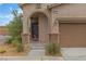 Home featuring covered entry with stone columns and desert landscaping at 10728 Brewster Bay St, Las Vegas, NV 89179