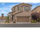 Charming two-story home with a large two car garage and tasteful desert landscaping at 10728 Brewster Bay St, Las Vegas, NV 89179