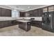 Kitchen with dark cabinets, white granite countertops, and stainless steel appliances at 10728 Brewster Bay St, Las Vegas, NV 89179