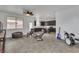 Open concept floorplan with tile flooring, kitchen with island and dark cabinets at 10728 Brewster Bay St, Las Vegas, NV 89179