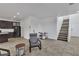 Open concept floorplan with tile flooring, kitchen with island and dark cabinets at 10728 Brewster Bay St, Las Vegas, NV 89179
