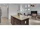 Open-concept living area featuring tile flooring, a cozy seating arrangement, and bright natural light at 10728 Brewster Bay St, Las Vegas, NV 89179