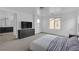 Spacious main bedroom with an ensuite bathroom, carpet, and a large window for ample natural light at 10728 Brewster Bay St, Las Vegas, NV 89179