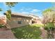 Backyard with artificial turf, privacy walls, and covered patio visible at 10741 Pearl River Ave, Las Vegas, NV 89166