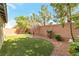 Manicured backyard with artificial turf, mature landscaping, and stone perimeter at 10741 Pearl River Ave, Las Vegas, NV 89166