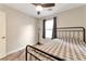Bedroom featuring a black metal bed frame, a ceiling fan, and a mirror at 10741 Pearl River Ave, Las Vegas, NV 89166