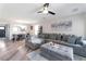 Spacious living room boasts a large sectional sofa, ceiling fan and stylish decor at 10741 Pearl River Ave, Las Vegas, NV 89166