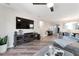 Open-concept living area featuring wood floors and an entertainment center at 10741 Pearl River Ave, Las Vegas, NV 89166