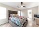 A bright main bedroom with a ceiling fan, natural light, and an ensuite bathroom at 10741 Pearl River Ave, Las Vegas, NV 89166