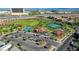 Aerial view of community featuring a park, tennis courts, playground, and green spaces, conveniently located near residential areas at 11242 Almador Vista Ct, Las Vegas, NV 89135