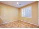 Cozy bedroom with neutral walls, plantation shutters, and tile flooring at 11242 Almador Vista Ct, Las Vegas, NV 89135