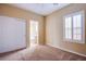 Cozy bedroom with neutral walls, carpet, closet and white shuttered window at 11242 Almador Vista Ct, Las Vegas, NV 89135
