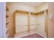 Walk-in closet features tan carpet and wood shelving at 11242 Almador Vista Ct, Las Vegas, NV 89135