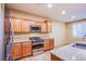 Bright kitchen featuring stainless steel appliances, granite countertops, and wood cabinets at 11242 Almador Vista Ct, Las Vegas, NV 89135