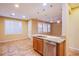 Open concept kitchen features an island, stainless steel appliances, and tile flooring at 11242 Almador Vista Ct, Las Vegas, NV 89135