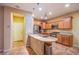 Well-lit kitchen features stainless steel appliances, wood cabinets, and granite countertops at 11242 Almador Vista Ct, Las Vegas, NV 89135