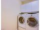 Convenient laundry area with a front-loading washer and dryer, and upper cabinets at 11242 Almador Vista Ct, Las Vegas, NV 89135