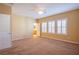 Spacious main bedroom with three windows, a ceiling fan, and neutral carpet at 11242 Almador Vista Ct, Las Vegas, NV 89135