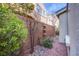 A view of a side yard with decorative rock and greenery at 11242 Almador Vista Ct, Las Vegas, NV 89135