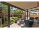 Serene backyard featuring a covered patio, lush lawn, mature trees, and a charming water fountain at 1161 Sax Fifth Ave, Henderson, NV 89052