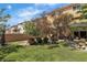 Lovely backyard featuring artificial grass, a fountain, and a covered patio with outdoor seating and shade at 1161 Sax Fifth Ave, Henderson, NV 89052