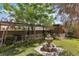 Charming backyard featuring a stone fountain, lush landscaping, and a covered patio for outdoor relaxation at 1161 Sax Fifth Ave, Henderson, NV 89052