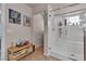 Walk-in shower with a seating bench and decorative shelving in this bright bathroom at 1161 Sax Fifth Ave, Henderson, NV 89052