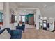 Inviting foyer with comfortable seating that provides a view of the adjacent living room with stairs nearby at 1161 Sax Fifth Ave, Henderson, NV 89052