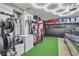 Spacious and well-equipped garage featuring ample storage, exercise equipment, and parking for a grey sedan at 1161 Sax Fifth Ave, Henderson, NV 89052