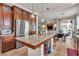Lovely kitchen with a large island, stainless steel appliances, and an adjacent dining area at 1161 Sax Fifth Ave, Henderson, NV 89052