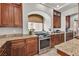 Kitchen with a gas range stove, granite countertops, and stylish dark wood cabinetry at 1161 Sax Fifth Ave, Henderson, NV 89052