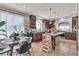 Charming kitchen with granite countertops, dark wood cabinetry, island and a cozy breakfast nook at 1161 Sax Fifth Ave, Henderson, NV 89052