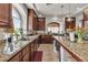 Well-lit kitchen showcases granite countertops, dark wood cabinets, and modern stainless-steel appliances at 1161 Sax Fifth Ave, Henderson, NV 89052