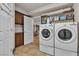 Well-organized laundry room featuring front load washer/dryer and lots of shelf space for storage at 1161 Sax Fifth Ave, Henderson, NV 89052
