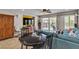 Comfortable living area with a large TV, wooden cabinet, sofa and outdoor access at 1161 Sax Fifth Ave, Henderson, NV 89052
