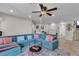 Spacious living room with an oversized sofa, ceiling fan and bright natural light at 1161 Sax Fifth Ave, Henderson, NV 89052