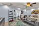 Cozy bedroom with a ceiling fan, shelving, sitting area and ample natural light at 1161 Sax Fifth Ave, Henderson, NV 89052