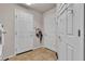 Functional mud room with white doors and convenient storage and wall hooks at 1161 Sax Fifth Ave, Henderson, NV 89052