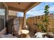 Inviting covered patio featuring a bamboo fence, seating, and a small table, creating a private outdoor retreat at 1161 Sax Fifth Ave, Henderson, NV 89052