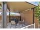 Cozy covered patio with a fire pit, seating, heater, and a bicycle, perfect for outdoor relaxation and entertainment at 1161 Sax Fifth Ave, Henderson, NV 89052