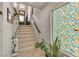 Staircase featuring neutral colors, a decorative window, plants and wood railings at 1161 Sax Fifth Ave, Henderson, NV 89052