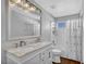 Well-lit bathroom featuring double sinks, a large mirror, and a shower with a tub at 1481 Rancho Ridge Dr, Henderson, NV 89012