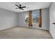 Comfortable bedroom with a ceiling fan, natural light, and a calming gray color scheme at 1481 Rancho Ridge Dr, Henderson, NV 89012