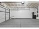 Spacious garage featuring epoxy flooring, storage shelves, and ample space for vehicles at 1481 Rancho Ridge Dr, Henderson, NV 89012