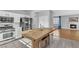 Open kitchen and living room layout with stainless steel appliances and wood burning fireplace at 1481 Rancho Ridge Dr, Henderson, NV 89012