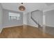 Spacious living room with hardwood floors, staircase, and contemporary light fixture at 1481 Rancho Ridge Dr, Henderson, NV 89012