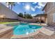 Backyard pool with lush desert landscaping and a covered pergola creating a perfect setting for relaxation at 1481 Rancho Ridge Dr, Henderson, NV 89012