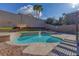 Backyard pool and spa surrounded by lush desert landscaping with a pergola providing shade for outdoor enjoyment at 1481 Rancho Ridge Dr, Henderson, NV 89012