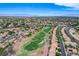 An aerial view of a sprawling community with lush landscaping, a golf course, and city views at 150 Wentworth Dr, Henderson, NV 89074